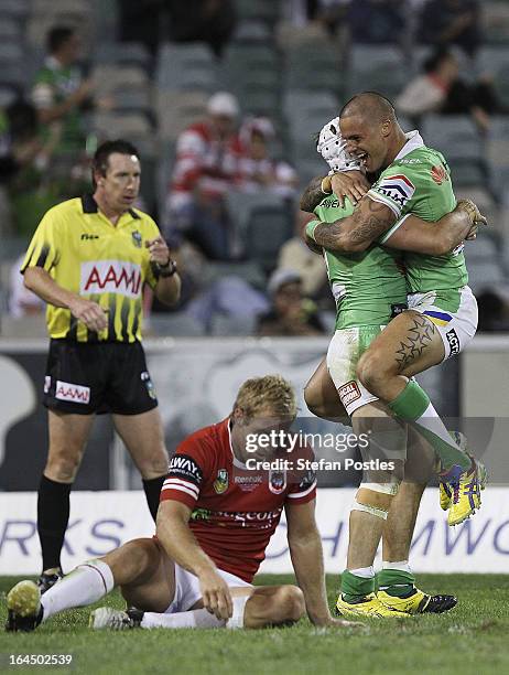 Sandor Earl congratulates Jarrod Croker of the Raiders after scoring a try during the round three NRL match between the Canberra Raiders and the St...