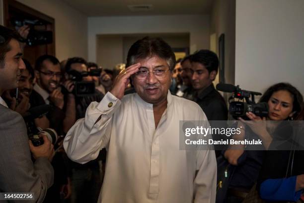 Former Pakistani president, Pervez Musharraf salutes as he arrives to brief media and supporters during a press conference ahead of his return, at...