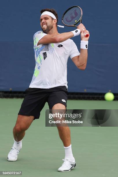 Jiri Vesely of the Czech Republic returns a shot against Enzo Couacaud of France during their Men's Singles First Round match on Day One of the 2023...