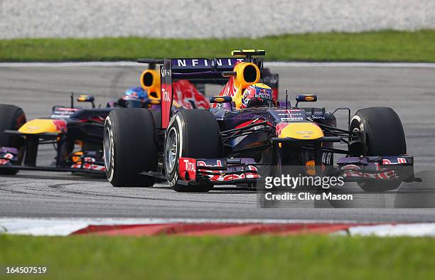 Mark Webber of Australia and Infiniti Red Bull Racing leads from Sebastian Vettel of Germany and Infiniti Red Bull Racing during the Malaysian...
