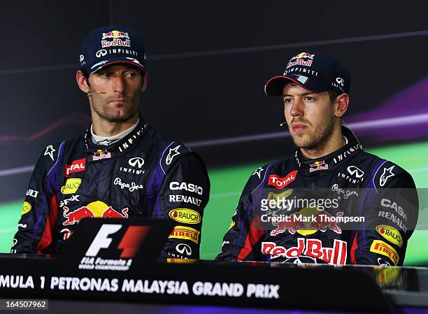 Race winner Sebastian Vettel of Germany and Infiniti Red Bull Racing and second placed Mark Webber of Australia and Infiniti Red Bull Racing react in...