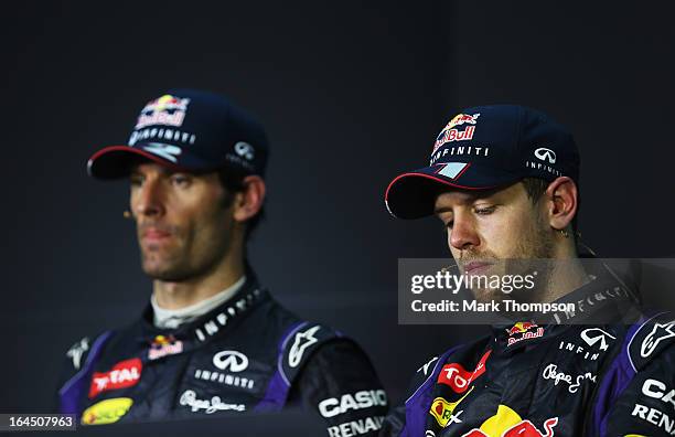 Race winner Sebastian Vettel of Germany and Infiniti Red Bull Racing and second placed Mark Webber of Australia and Infiniti Red Bull Racing react in...