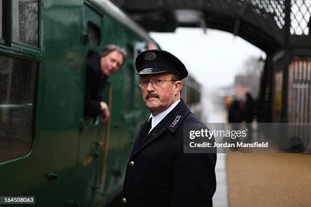 Conductor looks on as a locomotive arrives at Sheffield Park Station on March 23, 2013 in Fletching, England. The Bluebell Railway ran its first...