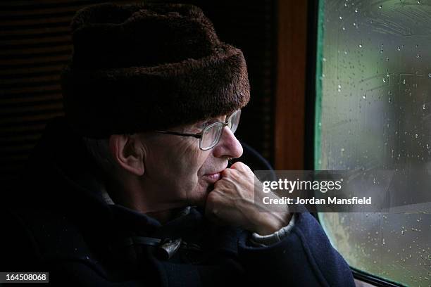 Man looks out a window as he rides a train from Sheffield Park to East Grinstead on March 23, 2013 in Horsted Keynes, EnglandThe Bluebell Railway ran...