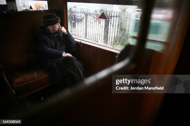 Man looks out a window as he rides a train from Sheffield Park to East Grinstead on March 23, 2013 in Horsted Keynes, EnglandThe Bluebell Railway ran...