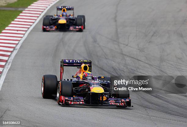 Mark Webber of Australia and Infiniti Red Bull Racing leads from team mate Sebastian Vettel of Germany and Infiniti Red Bull Racing during the...