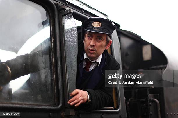 Driver looks on as he steers the first train into East Grinstead Station on March 23, 2013 in East Grinstead, England. The Bluebell Railway ran its...