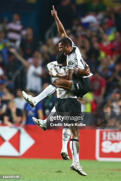 Samisoni Viriviri and Emosi Mulevoro of Fiji celebrate after winning the cup final match between Fiji and Wales during day three of the 2013 Hong...