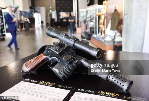Blaster prop used by Harrison Ford in the film ‘Star Wars: The Force Awakens’ is displayed during a media preview of ‘Legends: Hollywood & Royalty’...