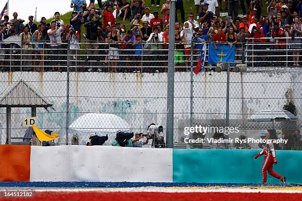 Fernando Alonso of Spain and Ferrari walks after he retired during the Malaysian Formula One Grand Prix at Sepang International Circuit on March 24,...