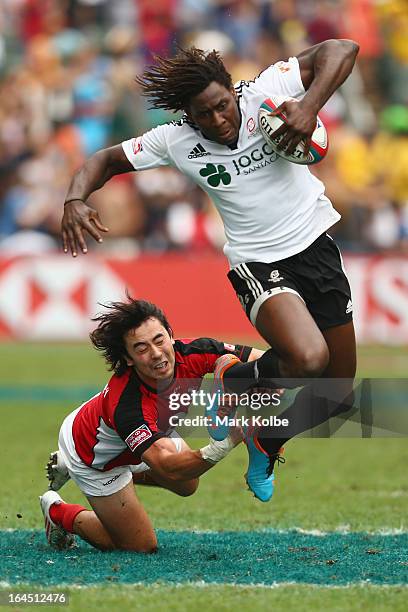 Aderito Esteves of Portugal breaks the tackle of Nathan Hirayama of Canada during the plate semi final match between Portugal and Canada day three of...