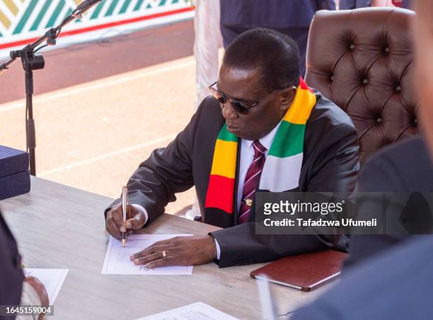 Zimbabwe's President Emmerson Mnangagwa signs the oath of office at his inauguration at a local stadium on September 4, 2023 in Harare, Zimbabwe....