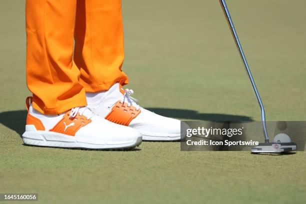 General view of Rickie Fowler's Puma shoes as he putts the ball during the final round of the 2023 Tour Championship on August 27, 2023 at East Lake...