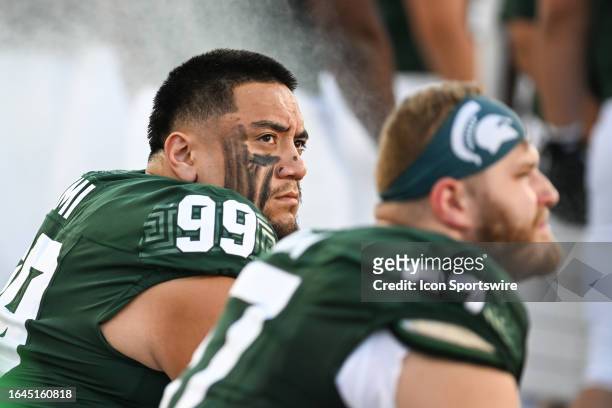 Michigan State Spartans defensive tackle Jalen Sami looks into the stands from the team bench during a college football game between the Michigan...