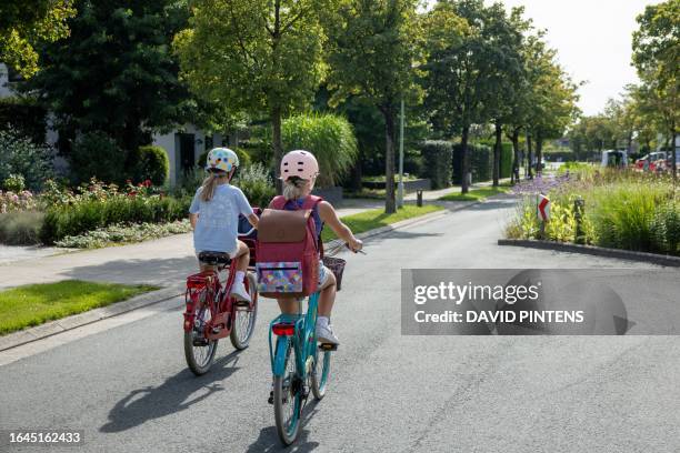 Illustration picture shows two girls enjoying a bike ride home from school, in Beveren, Monday 04 September 2023. The Royal Meteorological Institute...