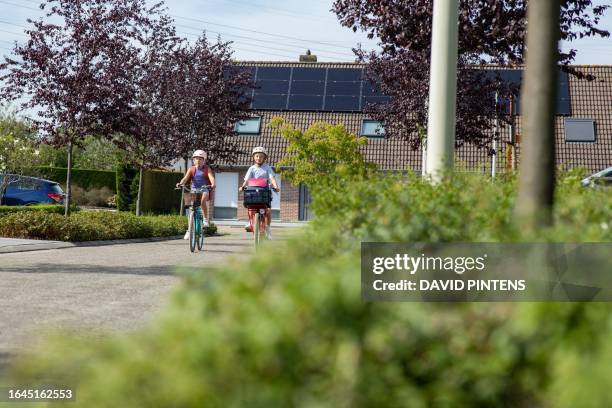 Illustration picture shows two girls enjoying a bike ride home from school, in Beveren, Monday 04 September 2023. The Royal Meteorological Institute...