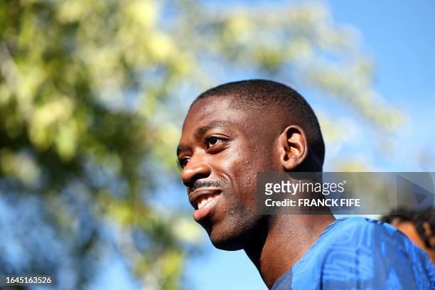 France's forward Ousmane Dembele arrives for a training session in Clairefontaine-en-Yvelines on September 4, 2023 as part of the team's preparation...