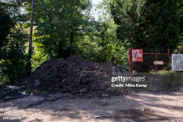 Piles of earth blocking the lane to The Crooked House pub in Himley where a fire broke out on the weekend amidst unexplained circumstances, and which...