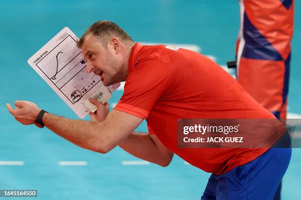 Romania's Head Coach Sergiu Stancu speaks with his players during the CEV EuroVolley 2023 Men Pool D match between France and Portugal at Shlomo...