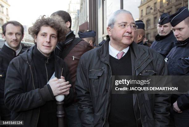 Ile-de-France regional council President Jean-Paul Huchon stands next to French policemen with Julien Bayou , one of the members of the Jeudi Noir...