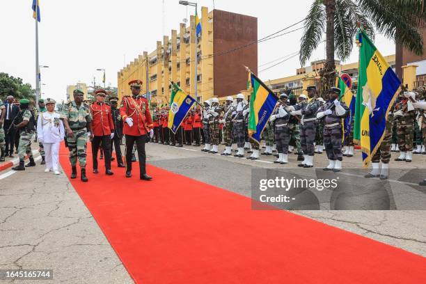 Gabon's new strongman General Brice Oligui Nguema , who was inaugurated as Gabon's interim President, reviews the troops before the military parade,...