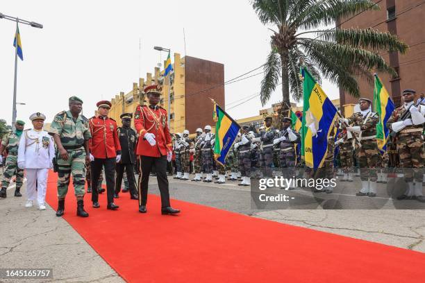 Gabon's new strongman General Brice Oligui Nguema , who was inaugurated as Gabon's interim President, reviews the troops before the military parade,...