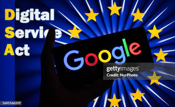 Google logo displayed on a smart phone with Digital Service Act seen in the background, in this photo illustration. On 04 September 2023 in Brussels,...