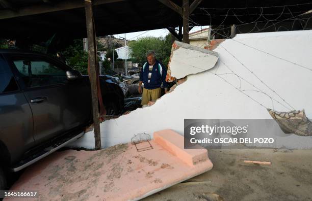 Resident looks at the damages caused by a flash flood at his home in the town of Villamanta, in the Madrid region on September 4 At least three...
