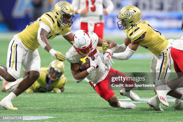 The Tech defense brings down Louisville Cardinals wide receiver Jamari Thrash during the AFLAC Kickoff Game between the Georgia Tech Yellow Jackets...