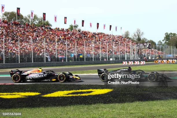 Sergio Perez of Red Bull Racing and George Russell of Mercedes during the Formula 1 Italian Grand Prix at Autodromo Nazionale di Monza in Monza,...