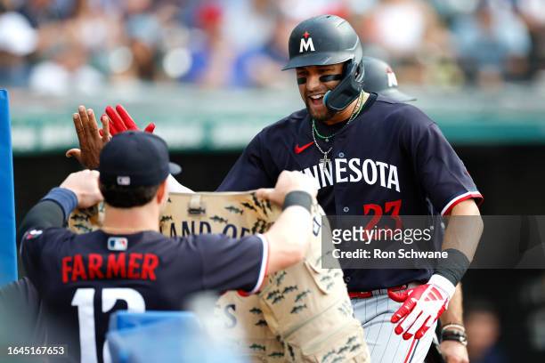 Royce Lewis of the Minnesota Twins celebrates with Kyle Farmer after hitting a grand slam off Lucas Giolito of the Cleveland Guardians during the...