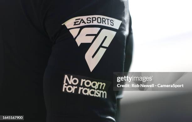 Close-up of the assistant referee's sleeve showing advertising for EA Sports and 'No room for racism' during the Premier League match between Crystal...