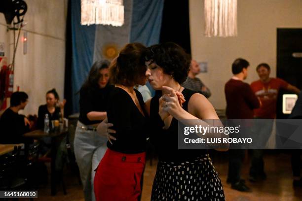 Couple dances tango at the milonga "Cañon", in La Tierra Invisible tango night club in Buenos Aires, Argentina, on September 1, 2023. In Buenos Aires...