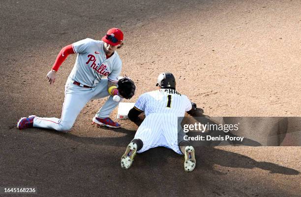 Trent Grisham of the San Diego Padres steals second base ahead of the tag of Bryson Stott of the Philadelphia Phillies during the fourth inning of a...