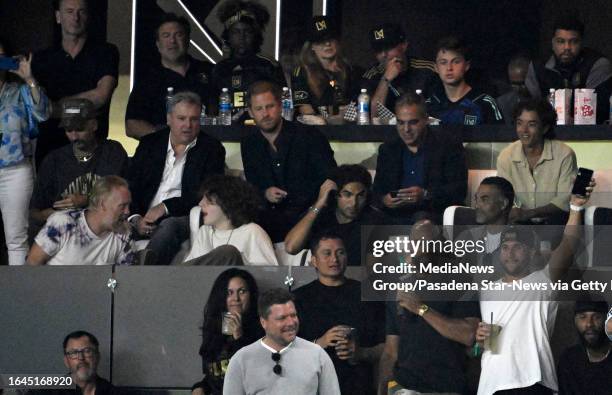 Los Angeles, CA David Peralta, right, of the Los Angeles Dodgers with teammates wave to the crowd as Prince Harry, Duke of Sussex, middle, looks on...