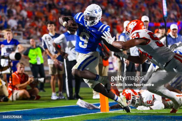 Jaquez Moore of the Duke Blue Devils scores a touchdown as Jeremiah Trotter Jr. #54 of the Clemson Tigers pushes him out of bounds during a football...