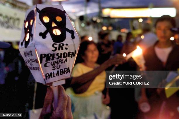 Group of people carrying torches and candles, demonstrate, 13 July 2001, during a protest against President Francisco Flores demanding that the...