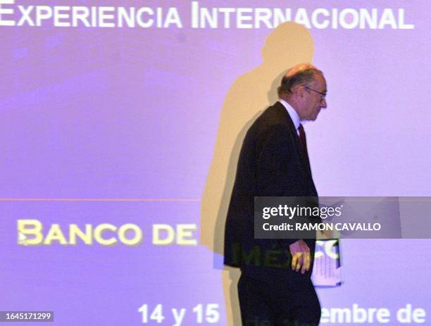 Alan Greenspan, chairman of the US Federal Reserve, walks to deliver a speech during a seminar hosted by Mexico's central bank 14 November 2000 in...