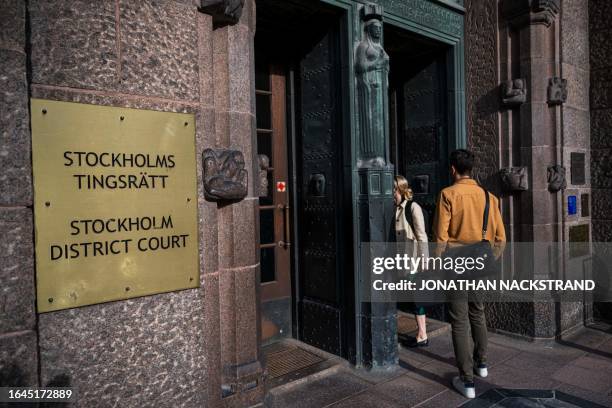 People enter the District Court in Stockholm, Sweden, on September 5 where two former executives at a Swedish oil company went on trial over...