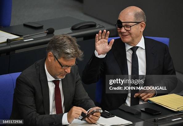 German Chancellor Olaf Scholz , wearing an eyepatch after injuring ...