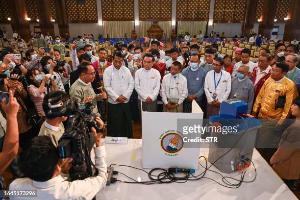 Members of Myanmar's Union Election Commission speak during a demonstration of voting machines to be used in future elections in Yangon on September...