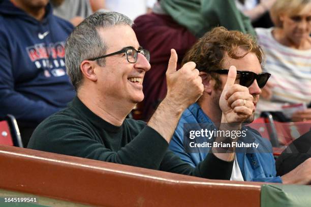 Personality and comedian John Oliver gives the thumbs up to the crowd before a game between the Houston Astros and the Boston Red Sox at Fenway Park...