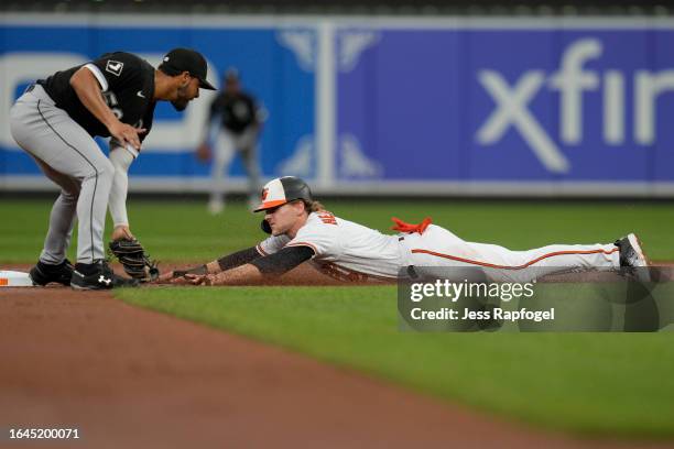 Gunnar Henderson of the Baltimore Orioles beats the tag by Lenyn Sosa of the Chicago White Sox as he steals second base during the first inning at...