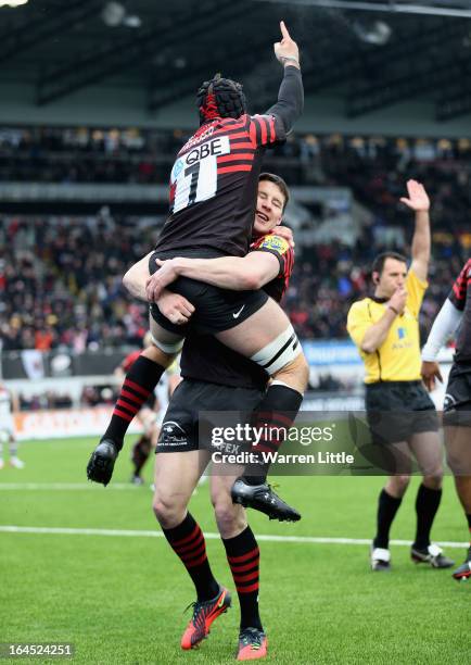 Will Fraser of Saracens is congratulated by Joel Tomkins after scoring a try during the Aviva Premiership match between Saracens and Harlequins at...