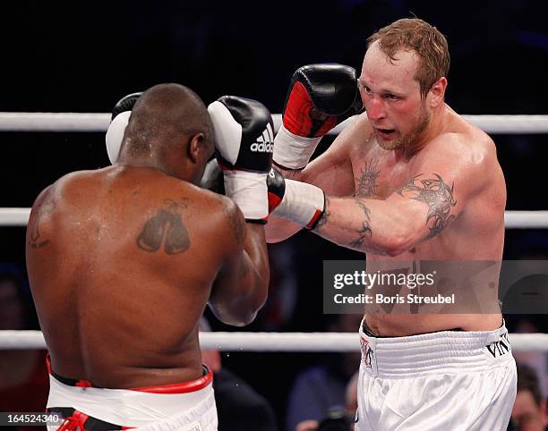 Michael Sprott of Great Britain and Robert Helenius of Finland box during their Heavyweight fight at Getec Arena on March 23, 2013 in Magdeburg,...