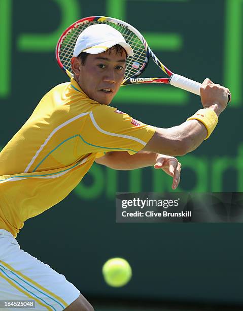 Kei Nishikori of Japan plays a backhand against Xavier Malisse of Belgium during their third round match at the Sony Open at Crandon Park Tennis...
