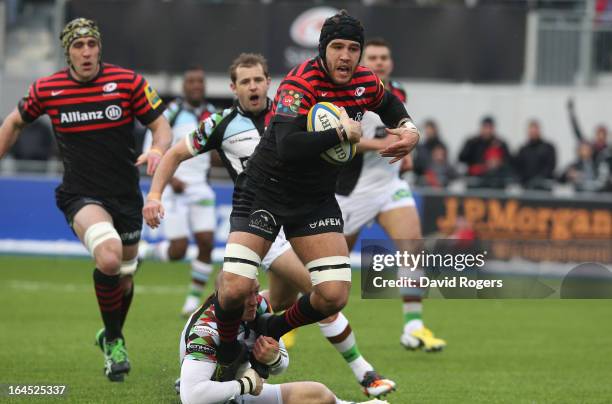 Will Fraser of Saracens is tackled by Mike Brown during the Aviva Premiership match between Saracens and Harlequins at Allianz Park on March 24, 2013...