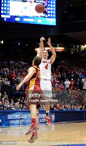 Aaron Craft of the Ohio State Buckeyes shoots a game-winning three point basket against Georges Niang of the Iowa State Cyclones late in the second...