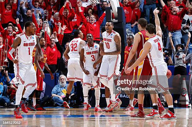 Deshaun Thomas, Shannon Scott and LaQuinton Ross of the Ohio State Buckeyes celebrate after Aaron Craft makes a three point basket late in the second...