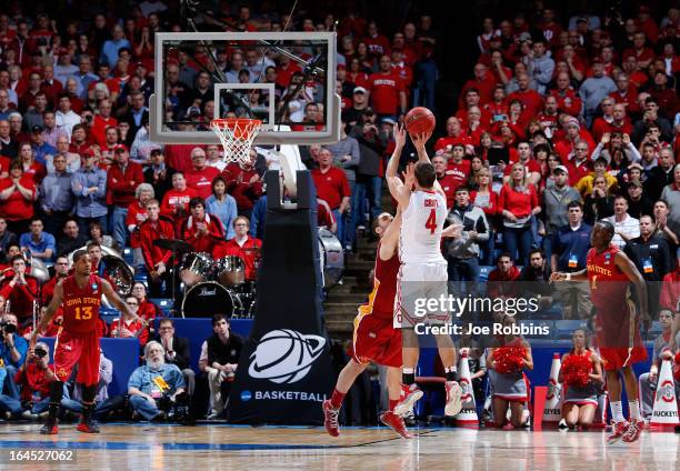 Aaron Craft of the Ohio State Buckeyes shoots a game-winning three point basket against Georges Niang of the Iowa State Cyclones late in the second...